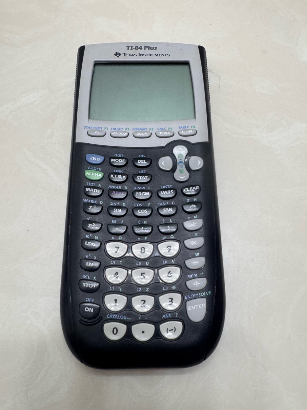 Texas Instruments TI-84 Plus Graphing Calculator in Black and Gray slide cover